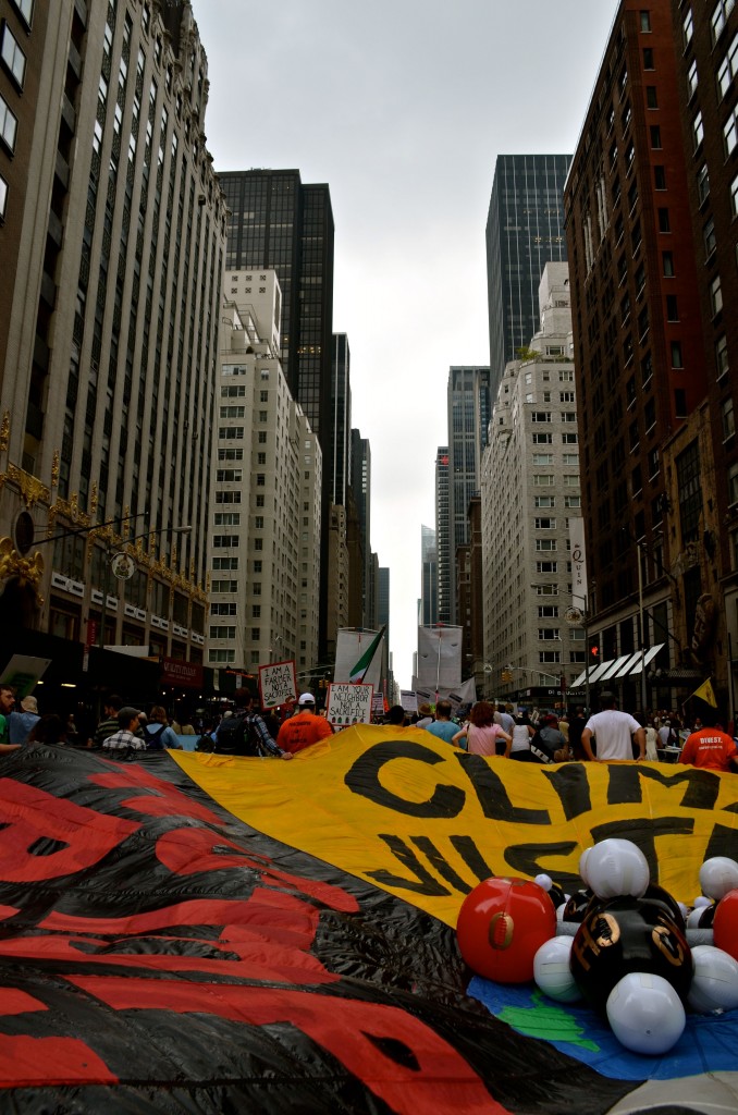 Surrounded by parachutes, signs and puppets, demonstrators make their way down 6th Avenue. Among the thousands were United Nations Secretary-General Ban Ki Moon, former Vice President Al Gore, Jane Goodall, Bill McKibben and Leonardo DiCaprio.