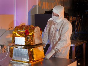 A NASA scientist prepares the Clouds and the Earth's Radiant Energy System (CERES) FM6 instrument for launch, February 2017.